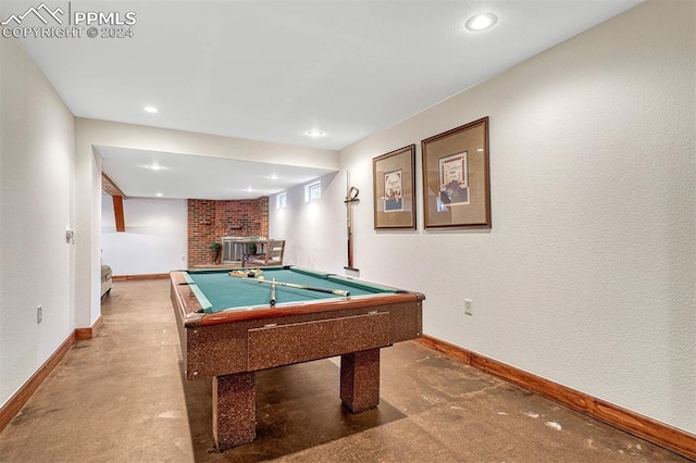 rec room featuring a brick fireplace, billiards, and concrete floors