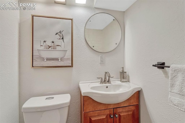 bathroom featuring toilet and vanity