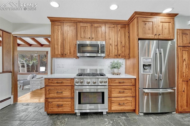 kitchen featuring tasteful backsplash, a baseboard heating unit, beamed ceiling, and stainless steel appliances