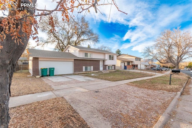 view of front of property with a front yard and a garage