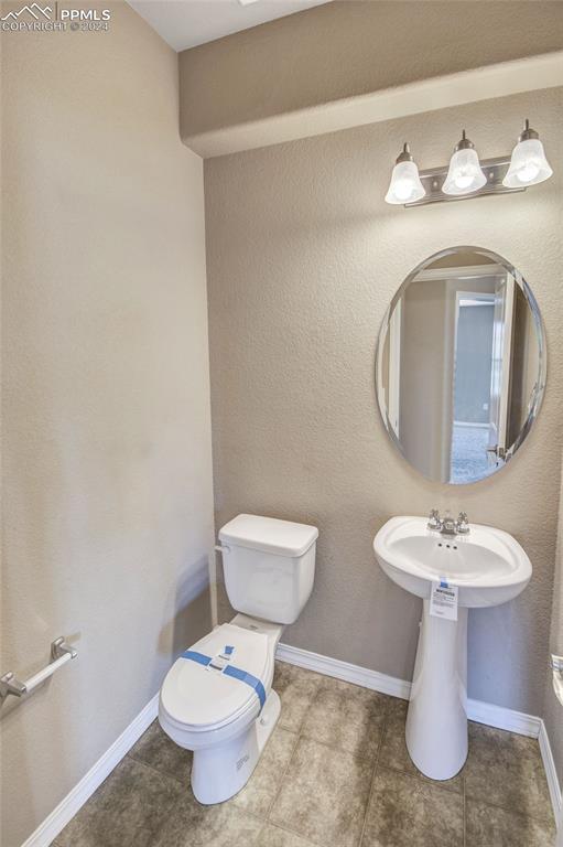 10978 Middlegate Ct, Peyton, CO 80831 - bathroom with toilet and tile patterned floors