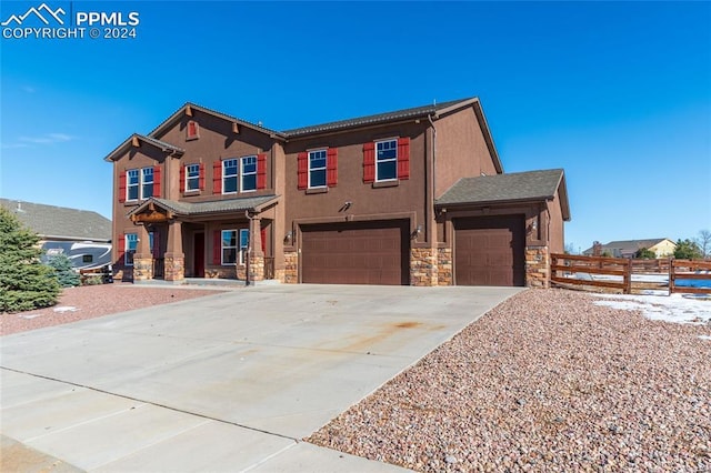 10978 Middlegate Ct, Peyton, CO 80831 - view of front facade featuring a garage, stone siding, concrete driveway, and covered porch