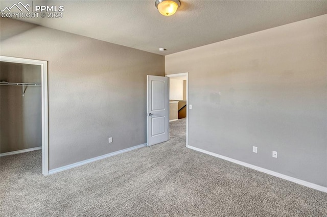 unfurnished bedroom with a closet and carpet floors