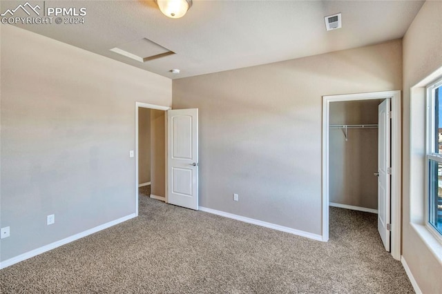 10978 Middlegate Ct, Peyton, CO 80831 - unfurnished bedroom with carpet flooring, a walk in closet, a closet, and baseboards