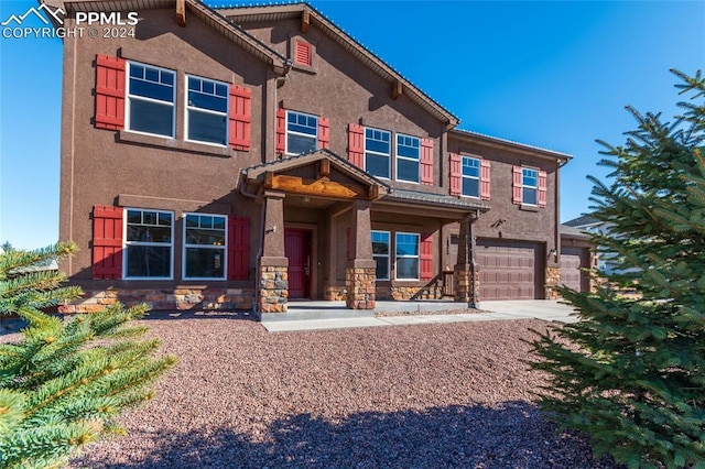 10978 Middlegate Ct, Peyton, CO 80831 - view of front of property featuring concrete driveway, a garage, stone siding, and stucco siding