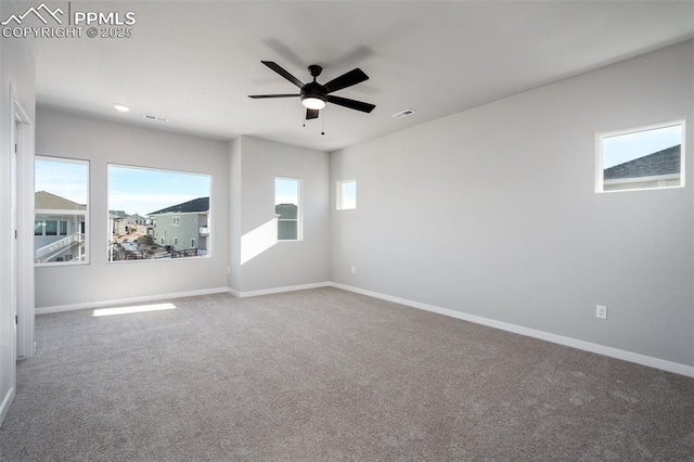 carpeted spare room featuring ceiling fan