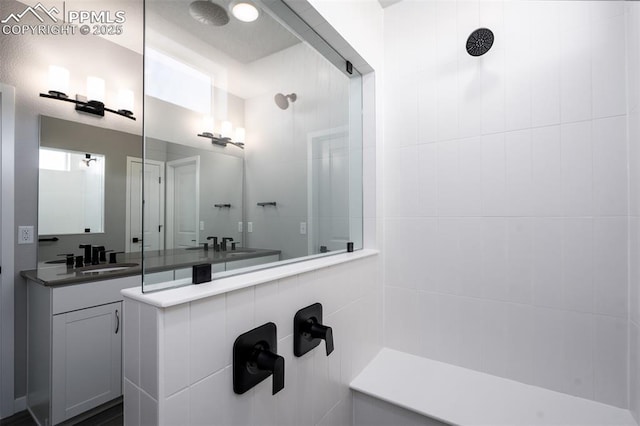 bathroom featuring a shower and vanity