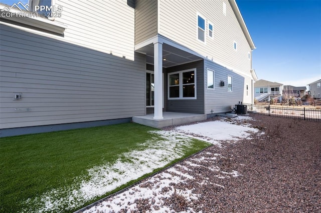 rear view of property featuring central AC unit, a patio area, and a yard