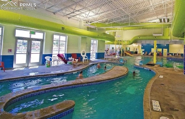 view of swimming pool featuring french doors