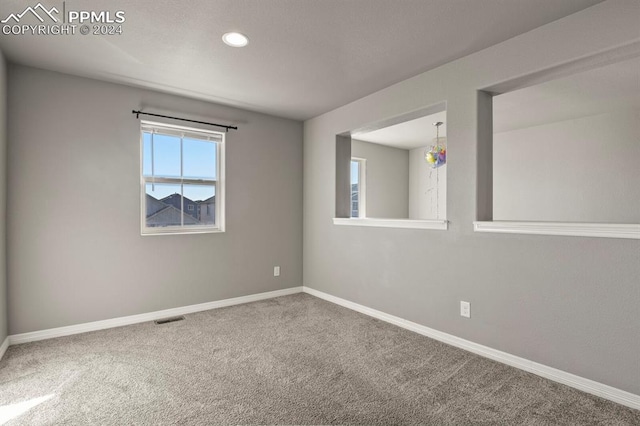 unfurnished room featuring carpet flooring