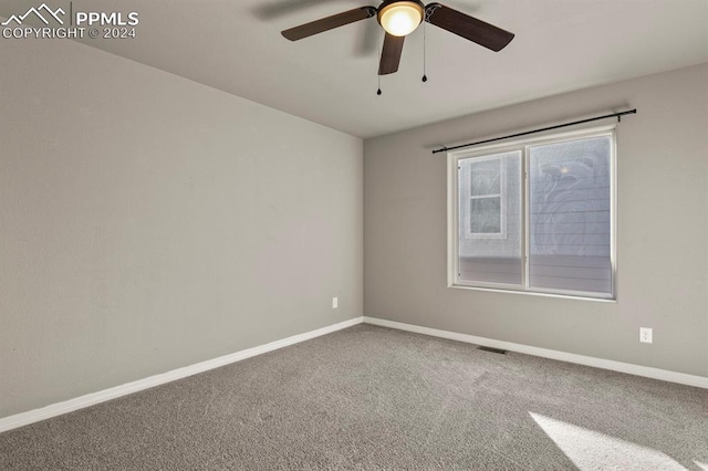 empty room featuring ceiling fan and carpet floors