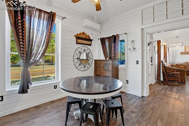 dining room featuring wood walls, ceiling fan, an AC wall unit, and dark hardwood / wood-style flooring