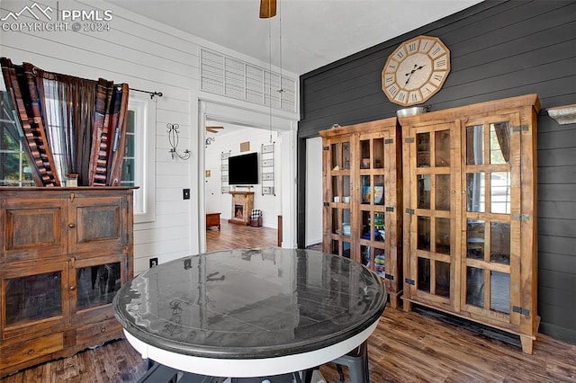 dining space featuring wooden walls and hardwood / wood-style flooring