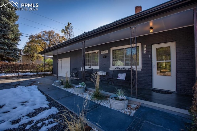 exterior space with a garage and covered porch