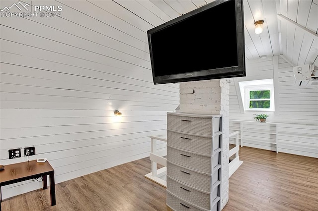 interior space featuring wood walls and hardwood / wood-style flooring