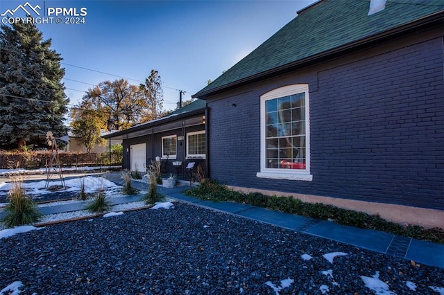 view of snow covered exterior with a garage