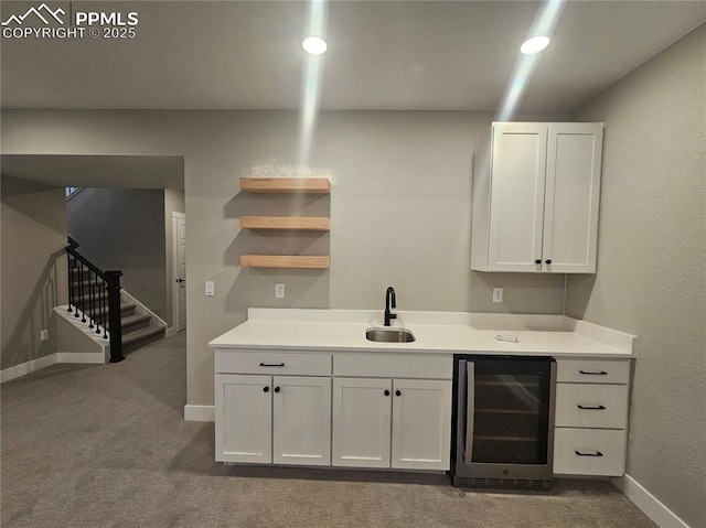 bar with wine cooler, light carpet, sink, and white cabinets