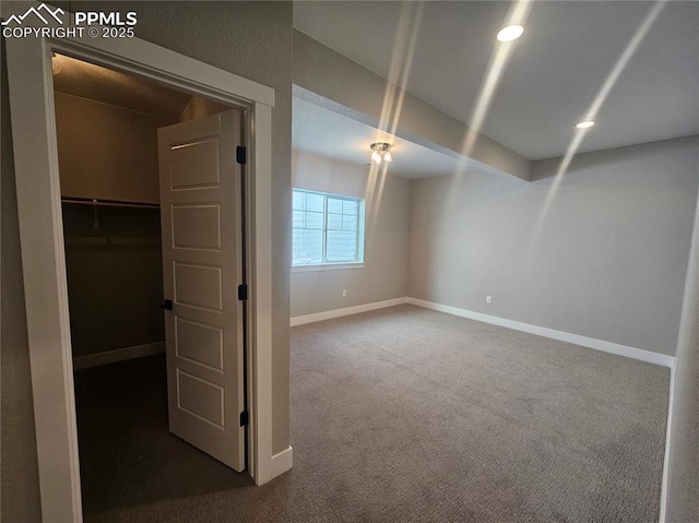 basement with dark colored carpet