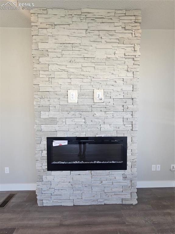 details featuring a fireplace and wood-type flooring