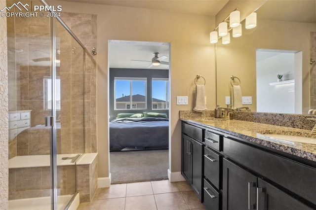 bathroom with tile patterned floors, ceiling fan, walk in shower, and vanity