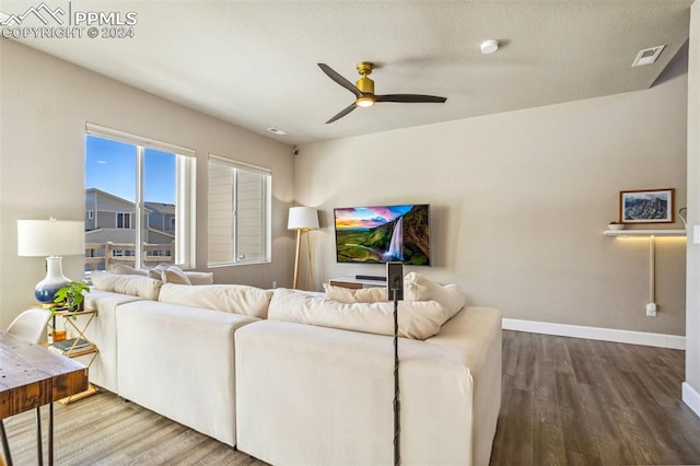 living room featuring ceiling fan and wood-type flooring