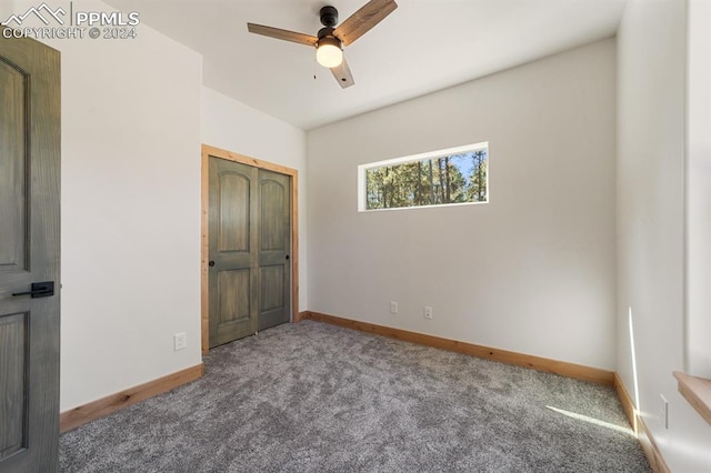 unfurnished bedroom with carpet floors and ceiling fan