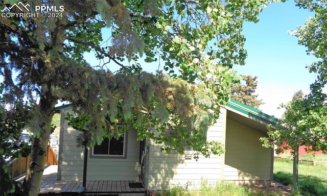 view of property exterior with a deck