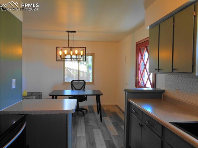 interior space with dark hardwood / wood-style floors, a healthy amount of sunlight, sink, and an inviting chandelier