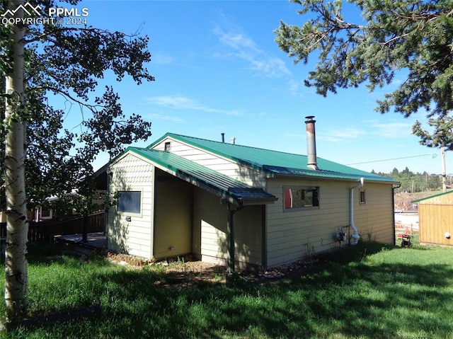 rear view of house with a yard