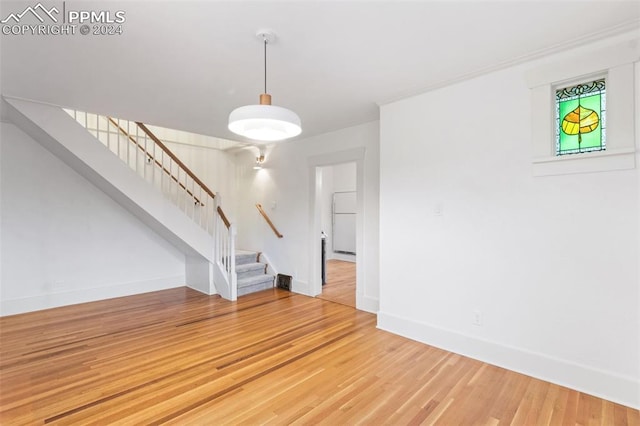 unfurnished living room with hardwood / wood-style flooring