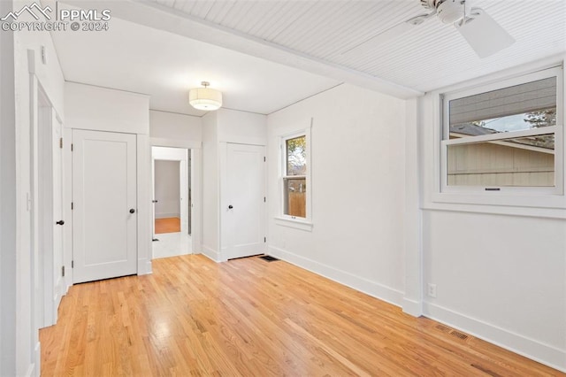 unfurnished bedroom with light wood-type flooring and ceiling fan