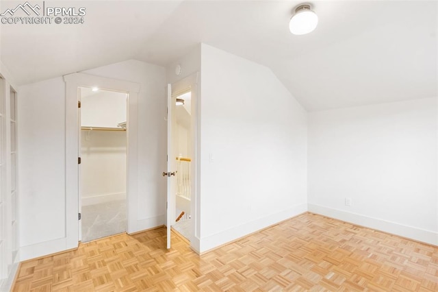 bonus room featuring light parquet floors and lofted ceiling