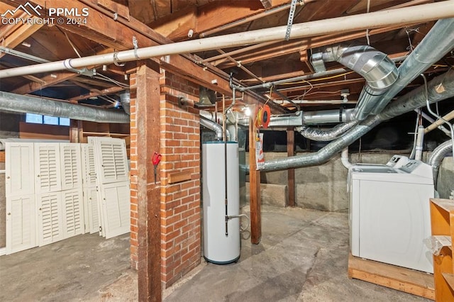 basement with water heater and washer and clothes dryer