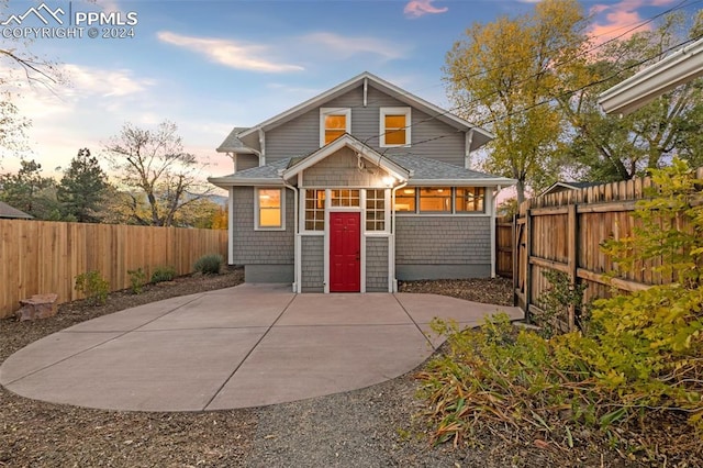 view of front of house featuring a sunroom and a patio