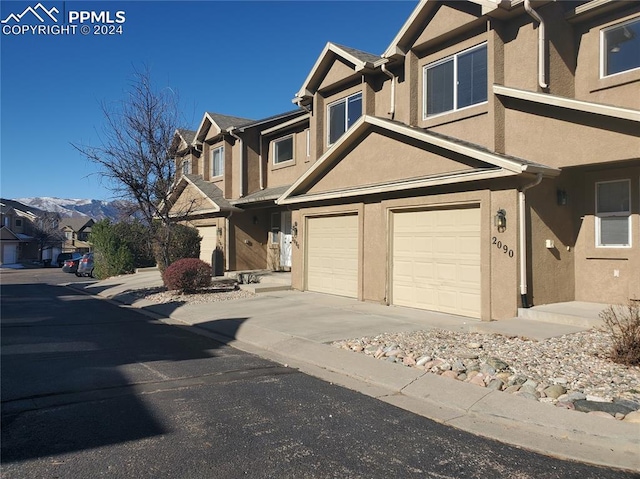 view of front of property featuring a mountain view and a garage