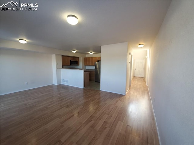 unfurnished living room with hardwood / wood-style flooring