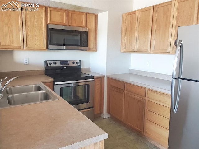 kitchen with sink and appliances with stainless steel finishes