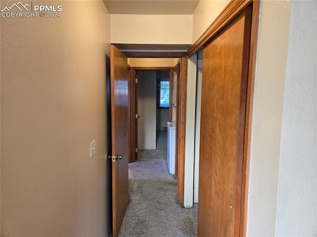 hallway featuring dark colored carpet