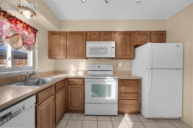 kitchen with sink, white appliances, and light tile patterned floors