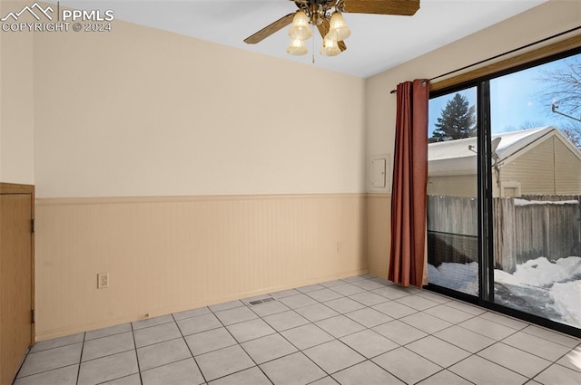 empty room with light tile patterned floors and ceiling fan