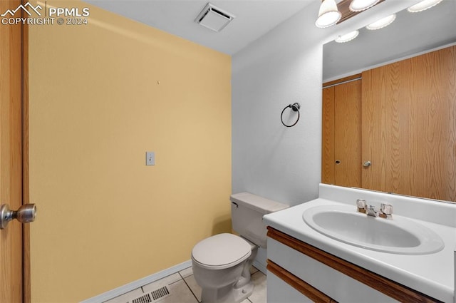 bathroom featuring vanity, tile patterned floors, and toilet