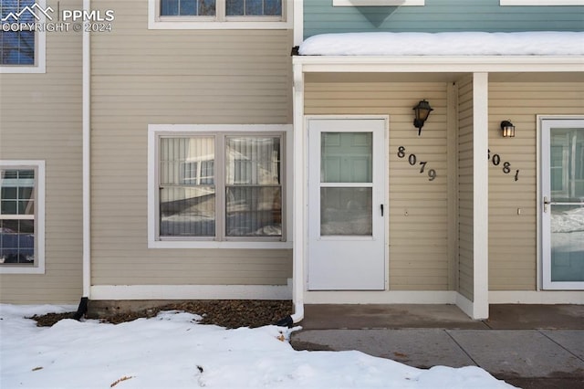 view of snow covered property entrance