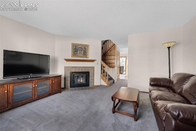 carpeted living room with a tiled fireplace