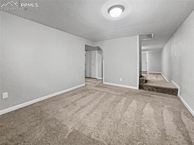 basement with carpet floors and a textured ceiling