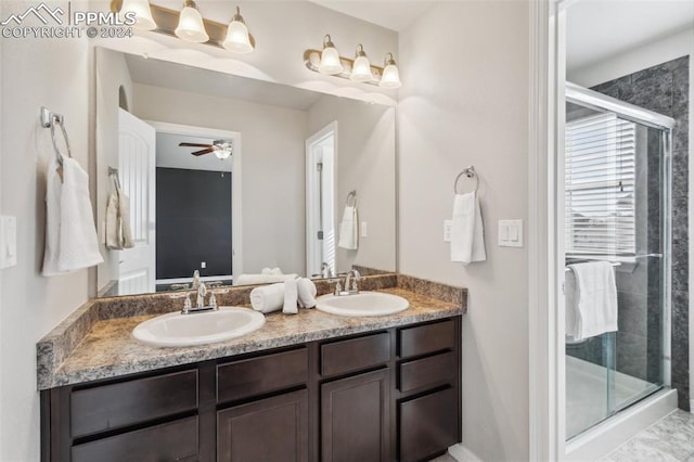 bathroom featuring ceiling fan, a shower with shower door, and vanity