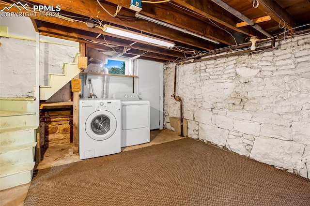 clothes washing area featuring separate washer and dryer