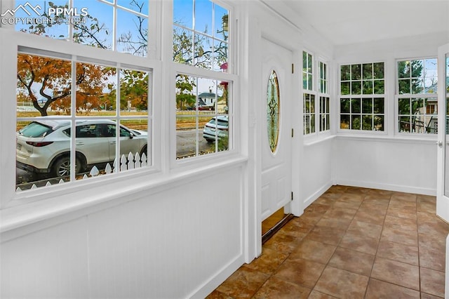 unfurnished sunroom featuring a healthy amount of sunlight