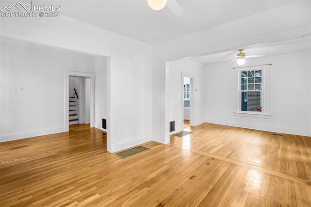 unfurnished living room featuring hardwood / wood-style floors and ceiling fan