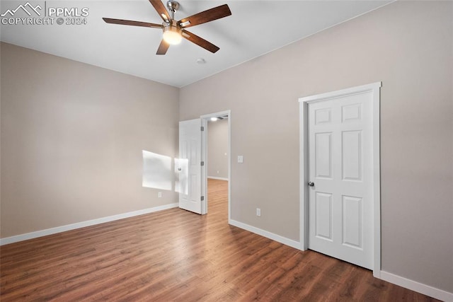 unfurnished bedroom with ceiling fan and dark hardwood / wood-style floors