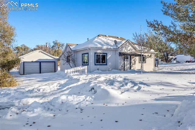 view of front of property with a garage and an outdoor structure